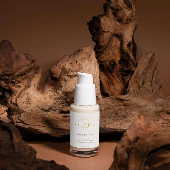 Sérum Perfecteur Visage OLyra Care sur un fond en bois, conçu pour unifier le teint et réduire les taches brunes.